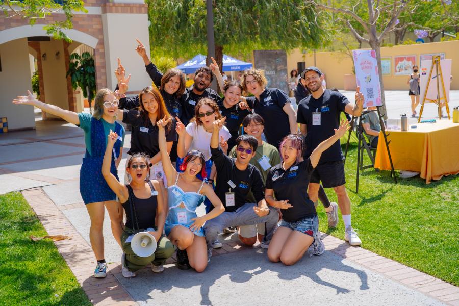 Students and staff posing in Sunset Village at an event